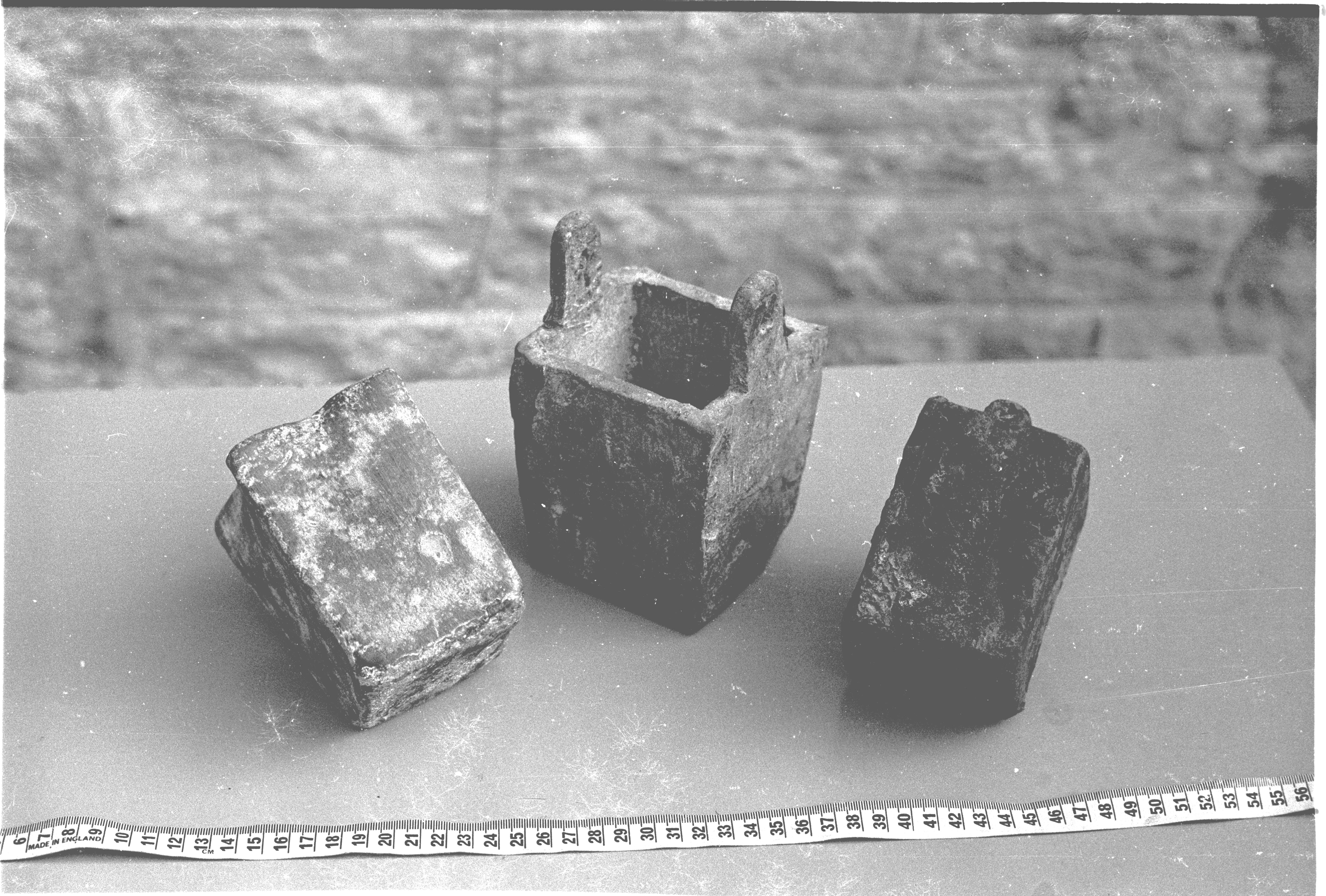 The three objects are lying close together showing different sides. The light in the old photo, although not ideal for the purpose, catches the gouge marks one corner of the Schiedam pot to the right, which help distinguish it from the others. The pots are very similar, but it seems the central one is slightly larger and that on the left lacks lugs.